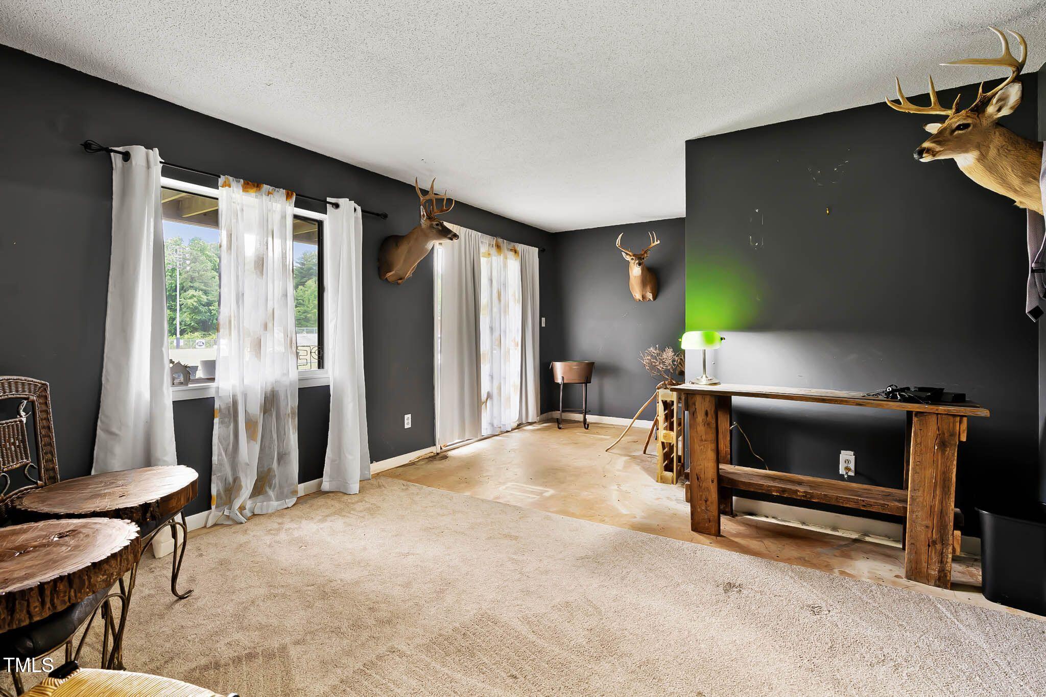 5931 Farm Gate Road Raleigh, NC 27606 - Photo 30 of 37 a living room with furniture and a flat screen tv