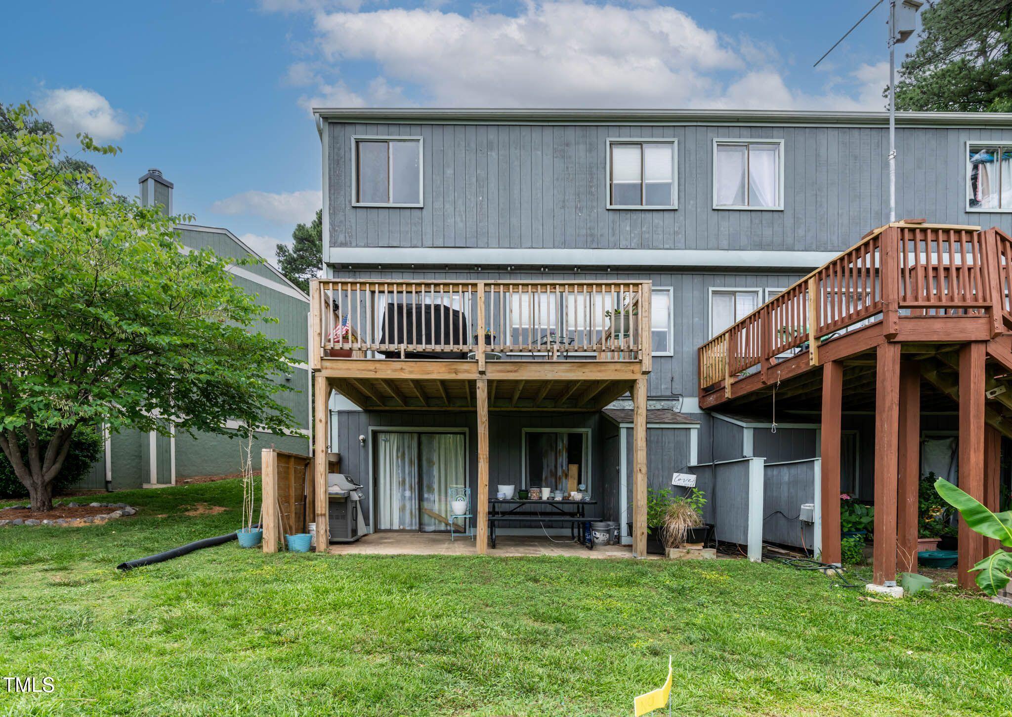 5931 Farm Gate Road Raleigh, NC 27606 - Photo 34 of 37 a view of an apartment with a deck and a garden