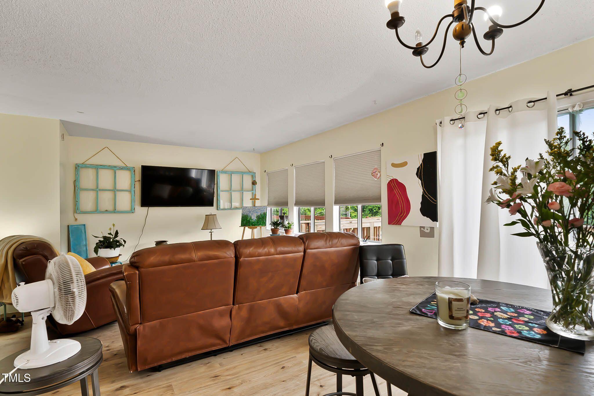 5931 Farm Gate Road Raleigh, NC 27606 - Photo 10 of 37 a living room with furniture and a flat screen tv