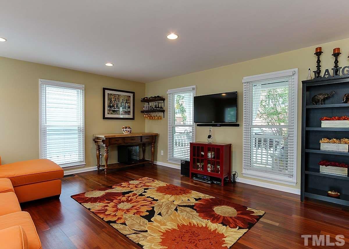416 East Martin Street Raleigh, NC 27601 - Photo 8 of 25 a living room with furniture a flat screen tv and a fireplace