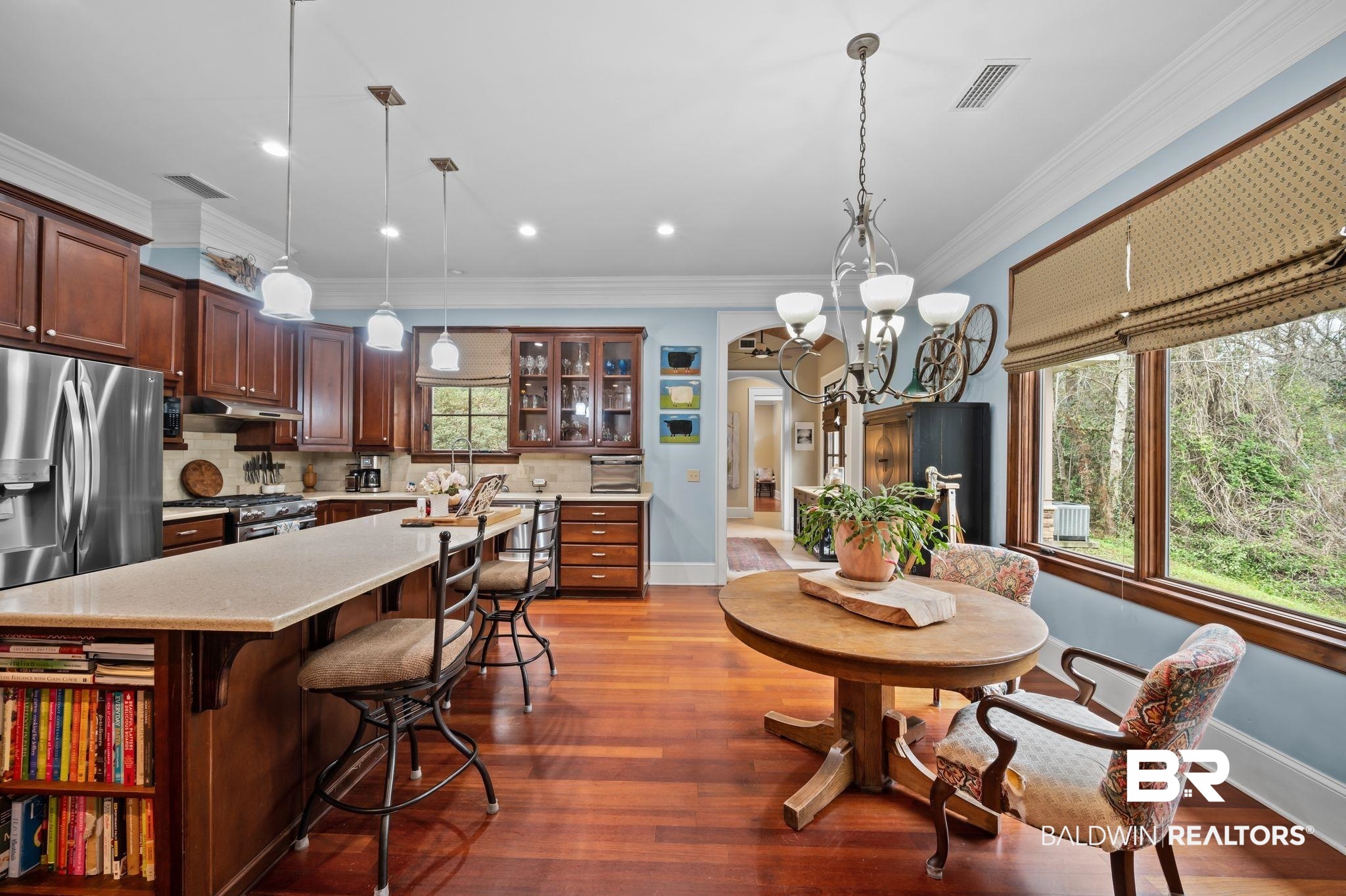7850 Yorkhaven Road Mobile, AL 36695 - Photo 14 of 57 Kitchen featuring visible vents, arched walkways, appliances with stainless steel finishes, under cabinet range hood, and tasteful backsplash