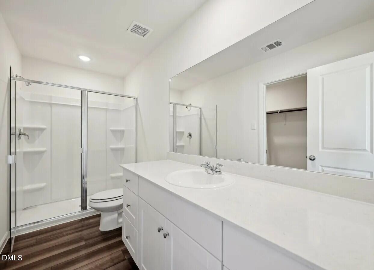 1345 Solace Way Rolesville, NC 27571 - Photo 24 of 24 a bathroom with a double vanity sink toilet and shower