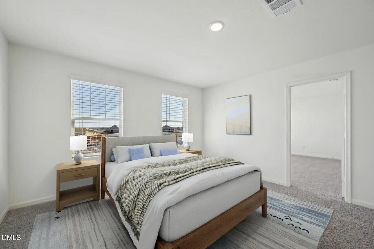 1345 Solace Way Rolesville, NC 27571 - Photo 8 of 24 a bedroom with a bed and wooden floor