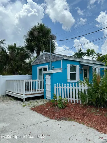 a view of a house with a small yard and plants