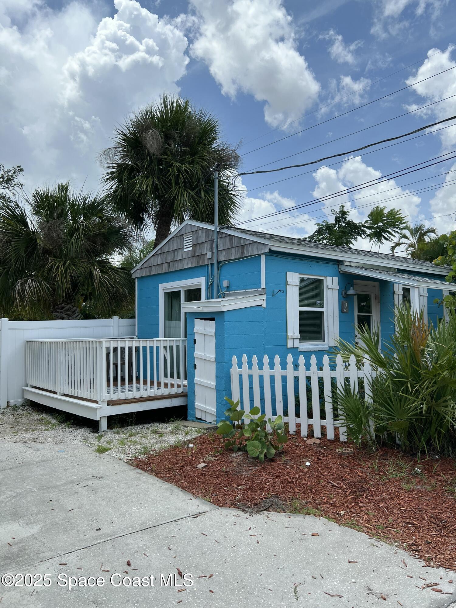 a view of a house with a small yard and plants