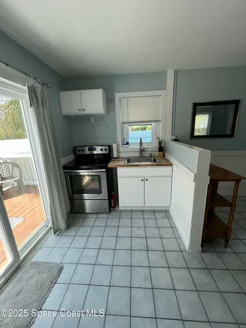 a kitchen with a stove a sink and a refrigerator