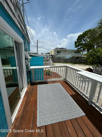 a view of balcony with wooden floor