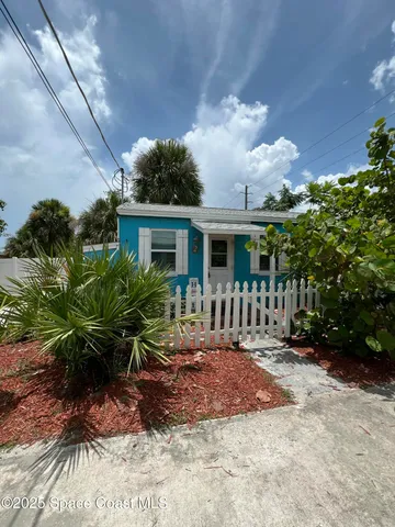 a view of a house with a yard and plants