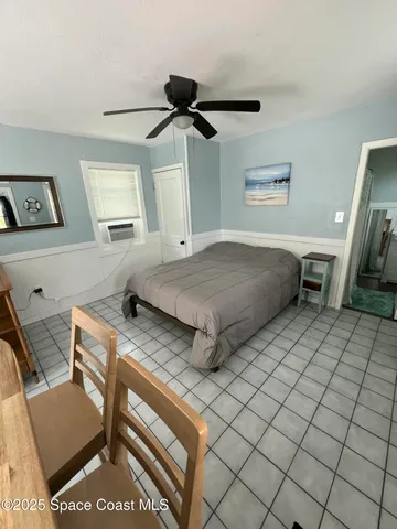 a bedroom with a bed and a mirror