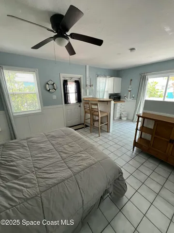 a bedroom with a bed a lamp and window