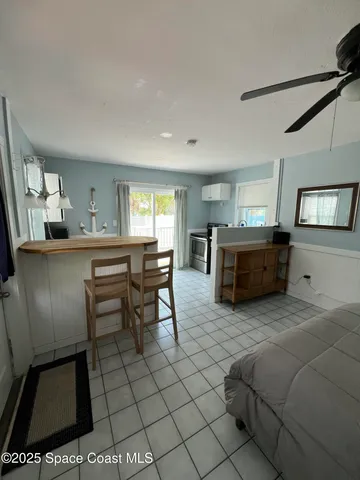 a living room with furniture a dining table and chairs
