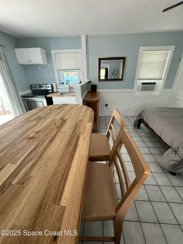 a bed room with a bed and a painting on the wall