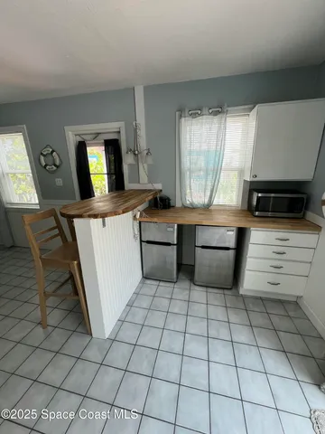 a room with a washing machine and cabinets