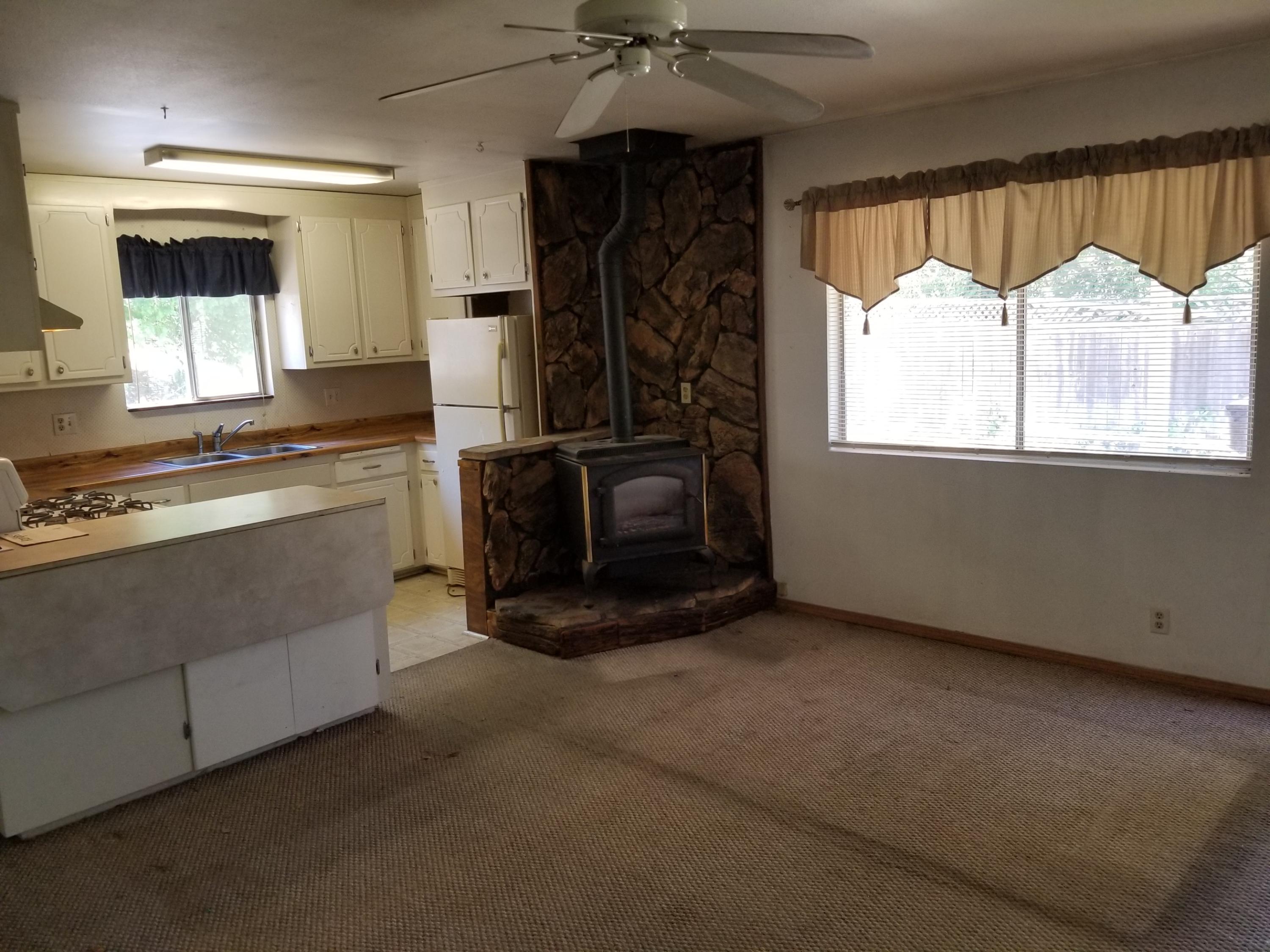 17843 Irish Road Redding, CA 96003 - Photo 4 of 13 a living room with furniture and a fireplace