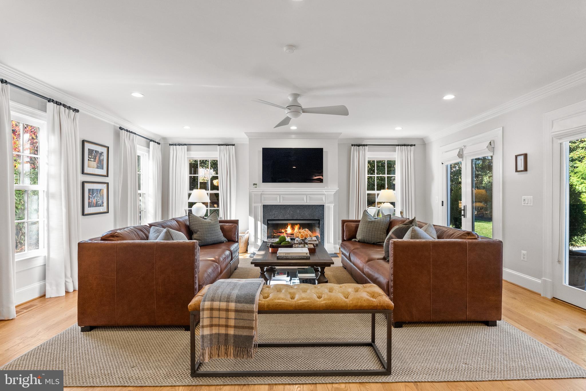 6032 Fort Hunt Road Alexandria, VA 22307 - Photo 2 of 49 a living room with furniture a flat screen tv and a fireplace
