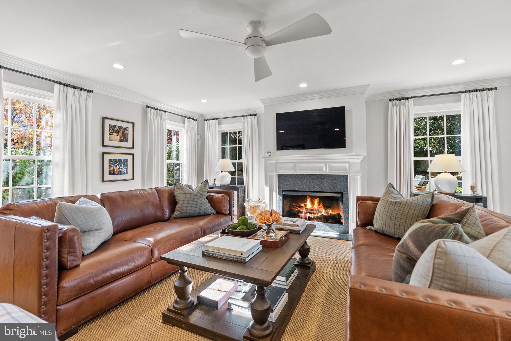 6032 Fort Hunt Road Alexandria, VA 22307 - Photo 23 of 49 a living room with furniture a flat screen tv and a fireplace
