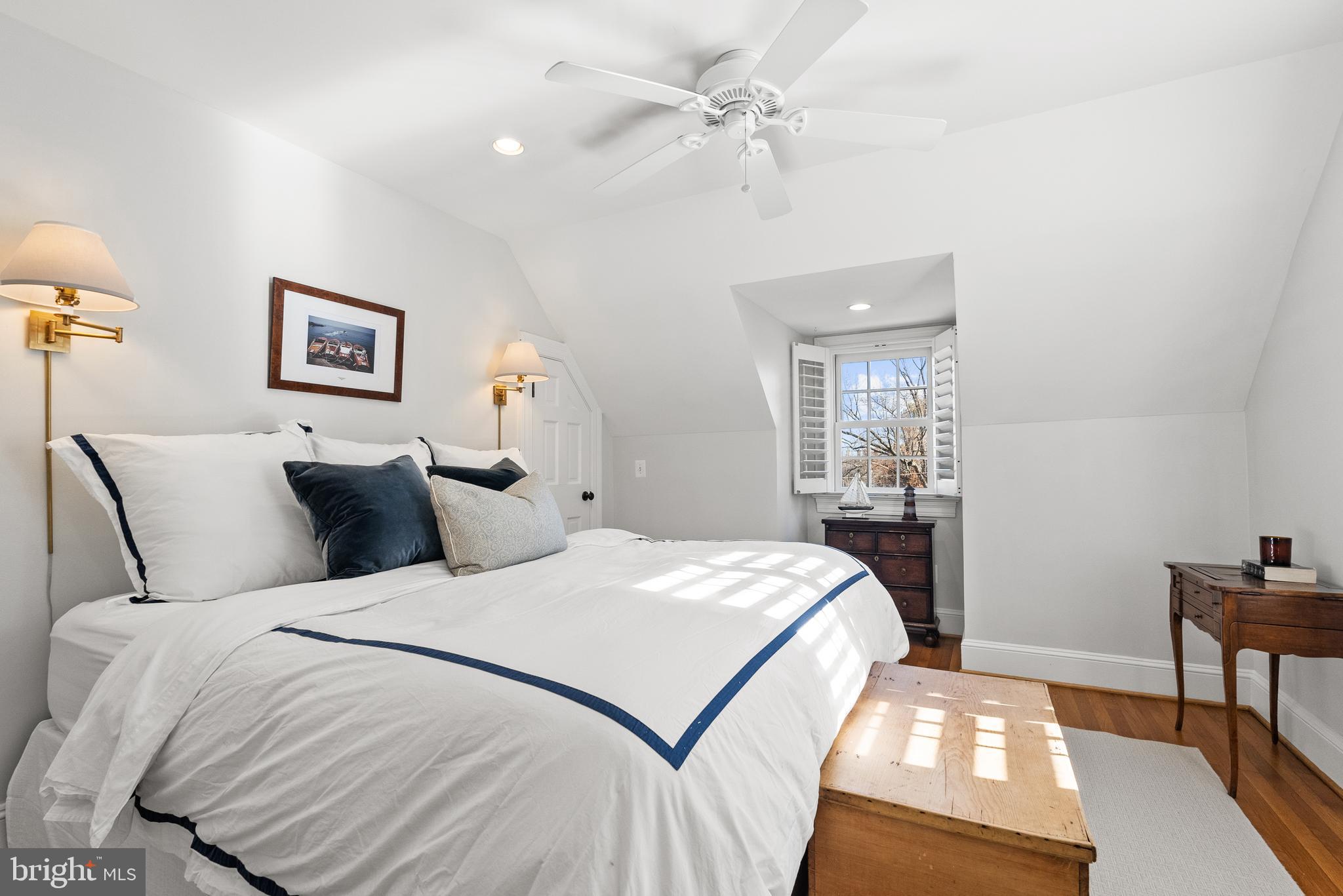 6032 Fort Hunt Road Alexandria, VA 22307 - Photo 30 of 49 a bedroom with a large bed and a chandelier