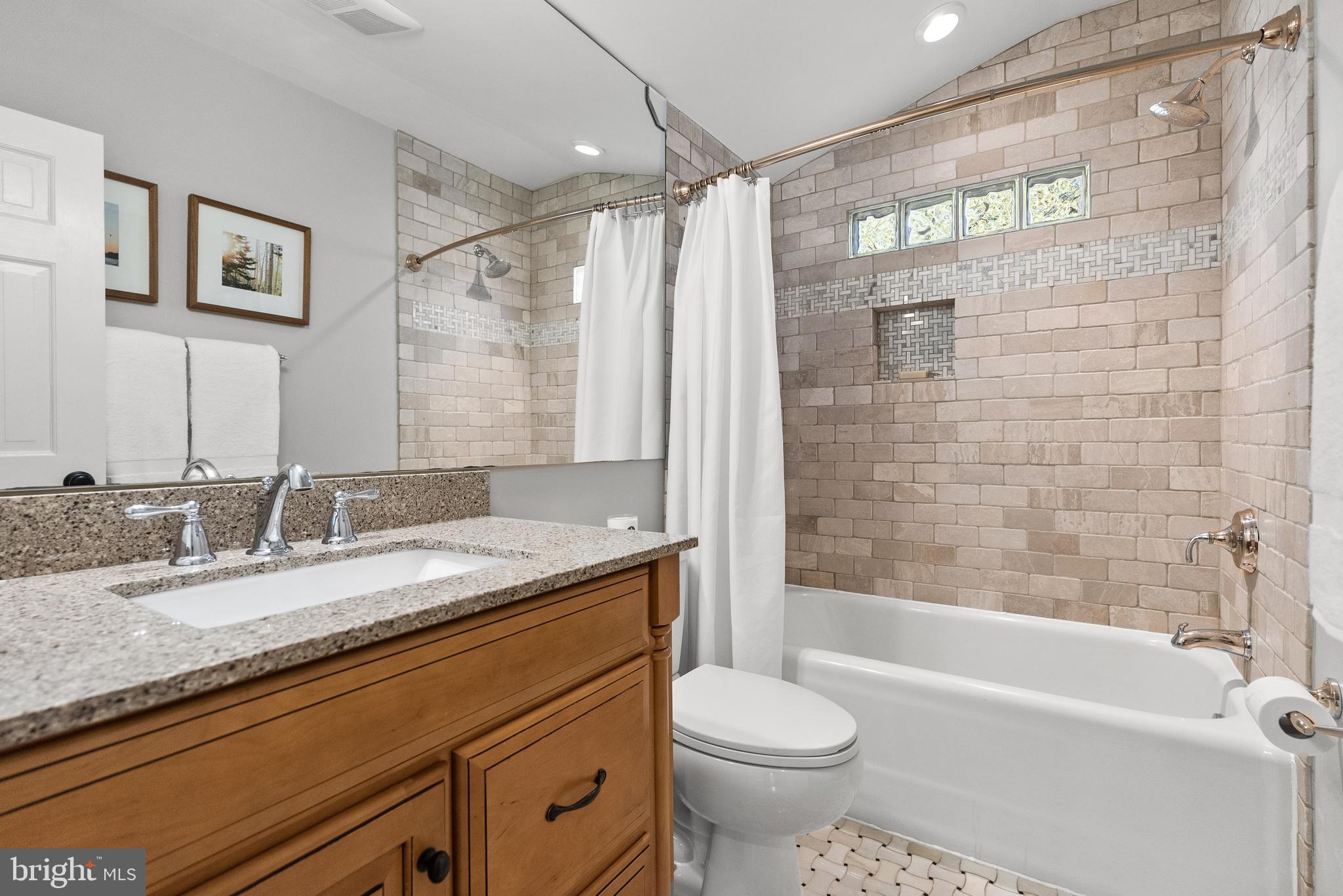 6032 Fort Hunt Road Alexandria, VA 22307 - Photo 34 of 49 a bathroom with a granite countertop sink toilet and shower
