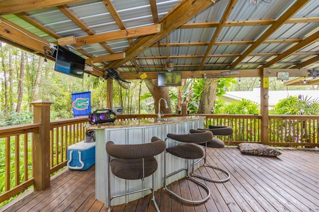 3341 Southeast 45th Street Ocala, FL 34480 - Photo 32 of 50 a balcony with furniture and wooden floor