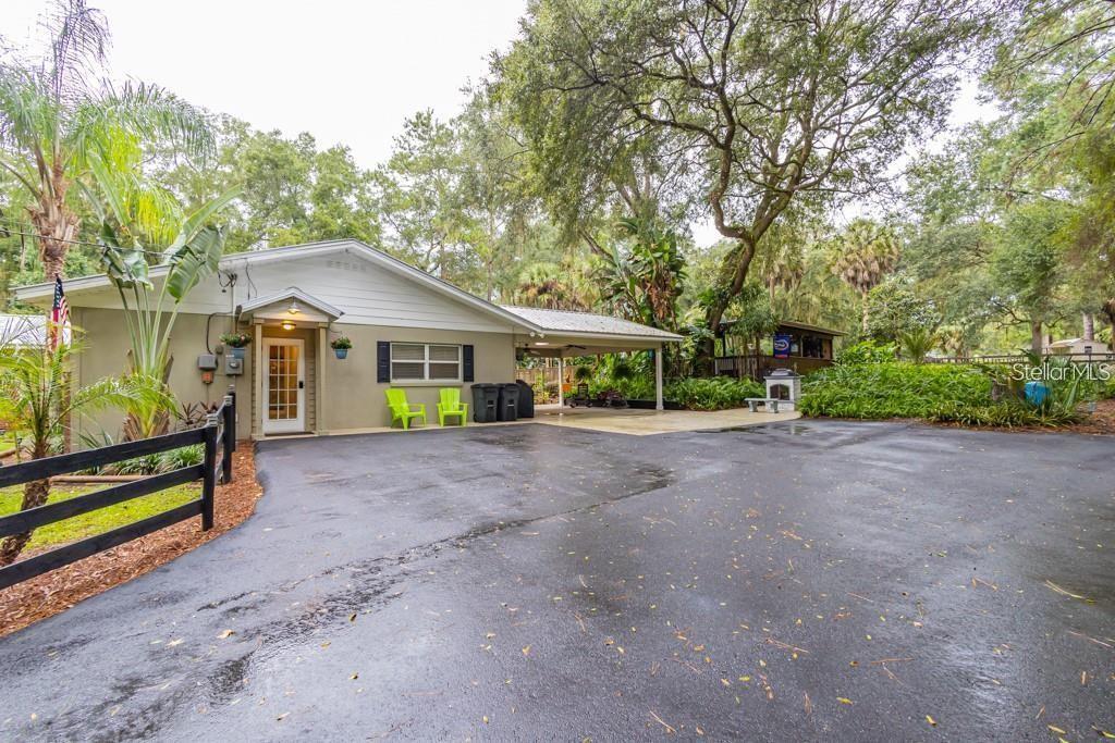 3341 Southeast 45th Street Ocala, FL 34480 - Photo 35 of 50 a view of a house with a yard and large trees