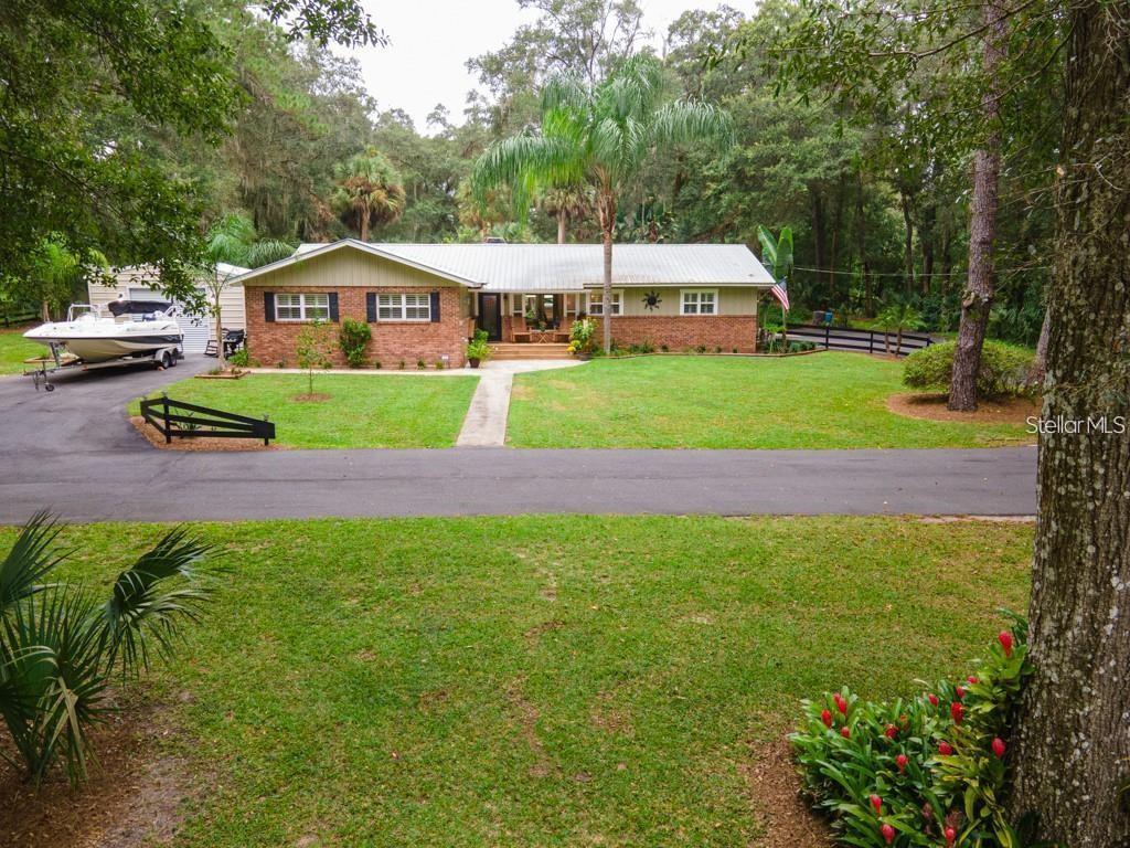 3341 Southeast 45th Street Ocala, FL 34480 - Photo 37 of 50 a front view of a house with a yard