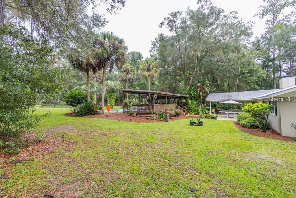 3341 Southeast 45th Street Ocala, FL 34480 - Photo 40 of 50 a view of a house with backyard and sitting area