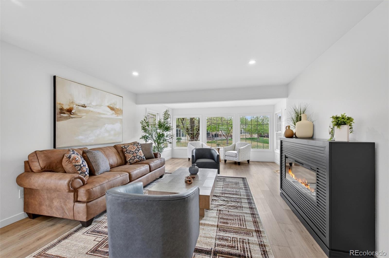 8943 Greenspointe Lane Highlands Ranch, CO 80130 - Photo 11 of 38 a living room with furniture and a fireplace