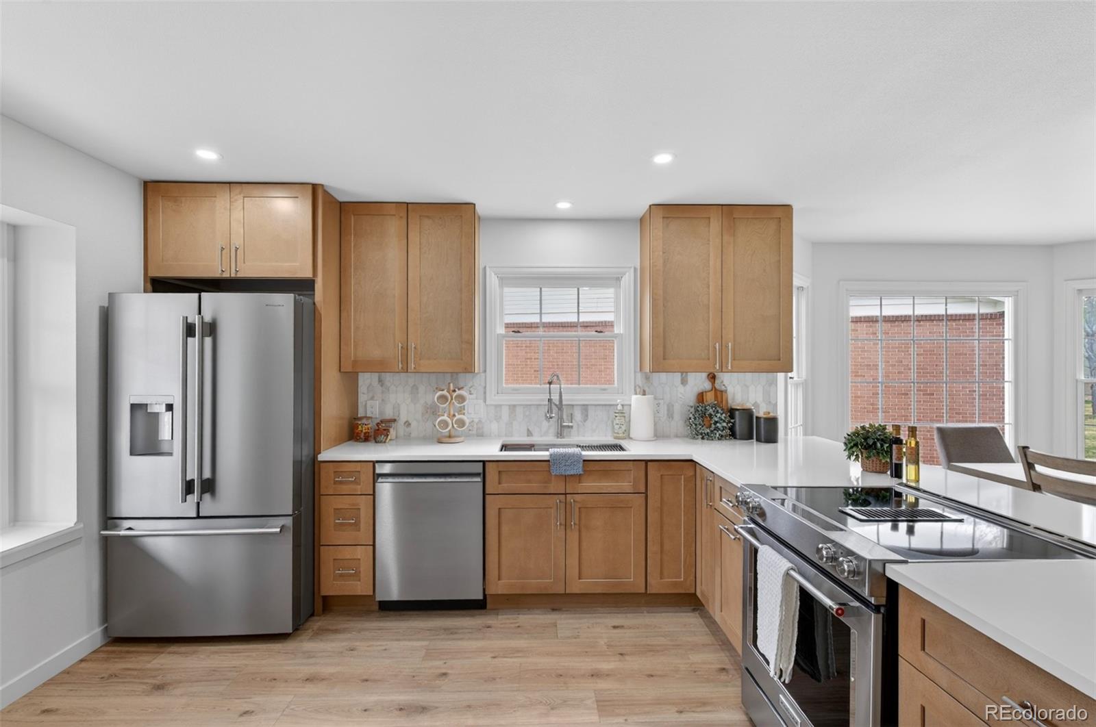 8943 Greenspointe Lane Highlands Ranch, CO 80130 - Photo 2 of 38 a kitchen with a sink stove and refrigerator