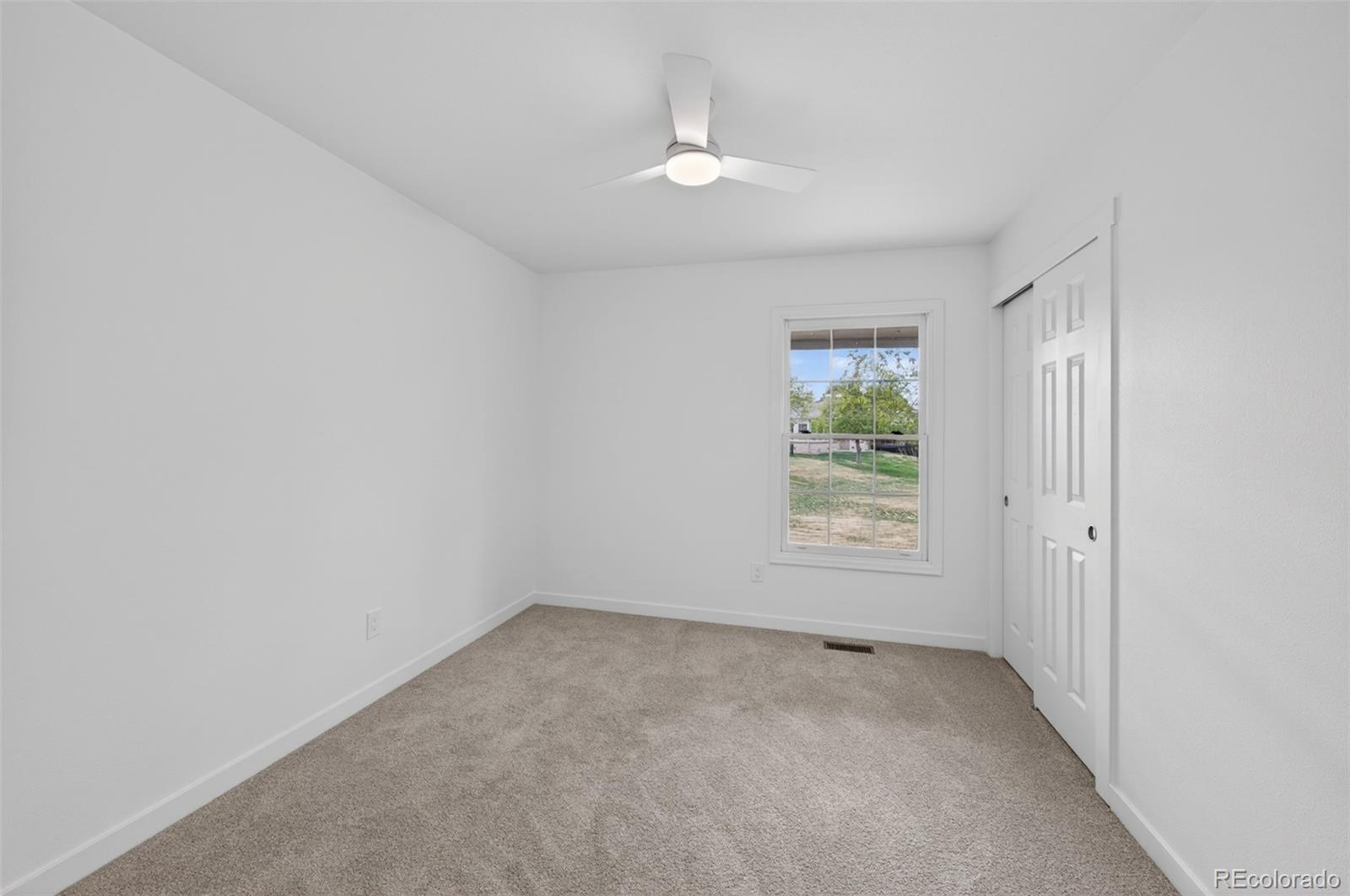 8943 Greenspointe Lane Highlands Ranch, CO 80130 - Photo 21 of 38 an empty room with a window