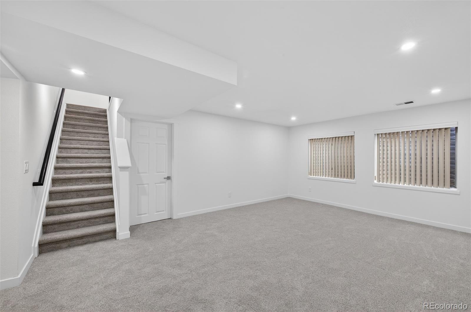 8943 Greenspointe Lane Highlands Ranch, CO 80130 - Photo 23 of 38 a view of an empty room with stairs