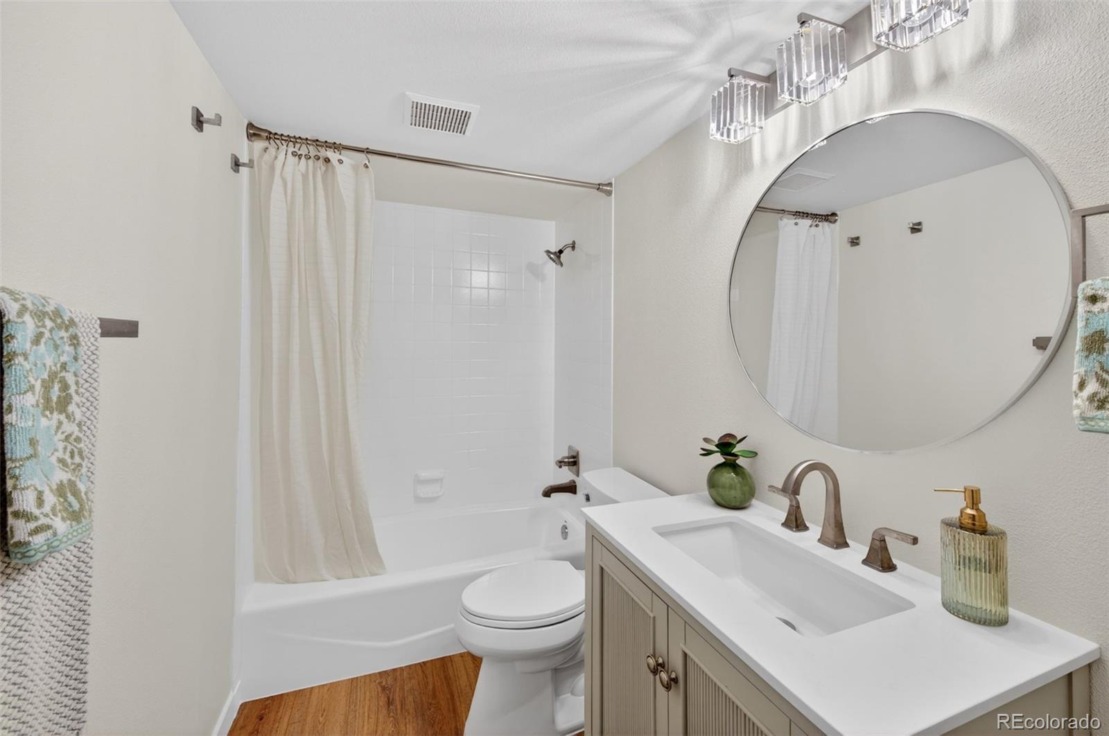 8943 Greenspointe Lane Highlands Ranch, CO 80130 - Photo 26 of 38 a bathroom with a sink a toilet and shower curtain