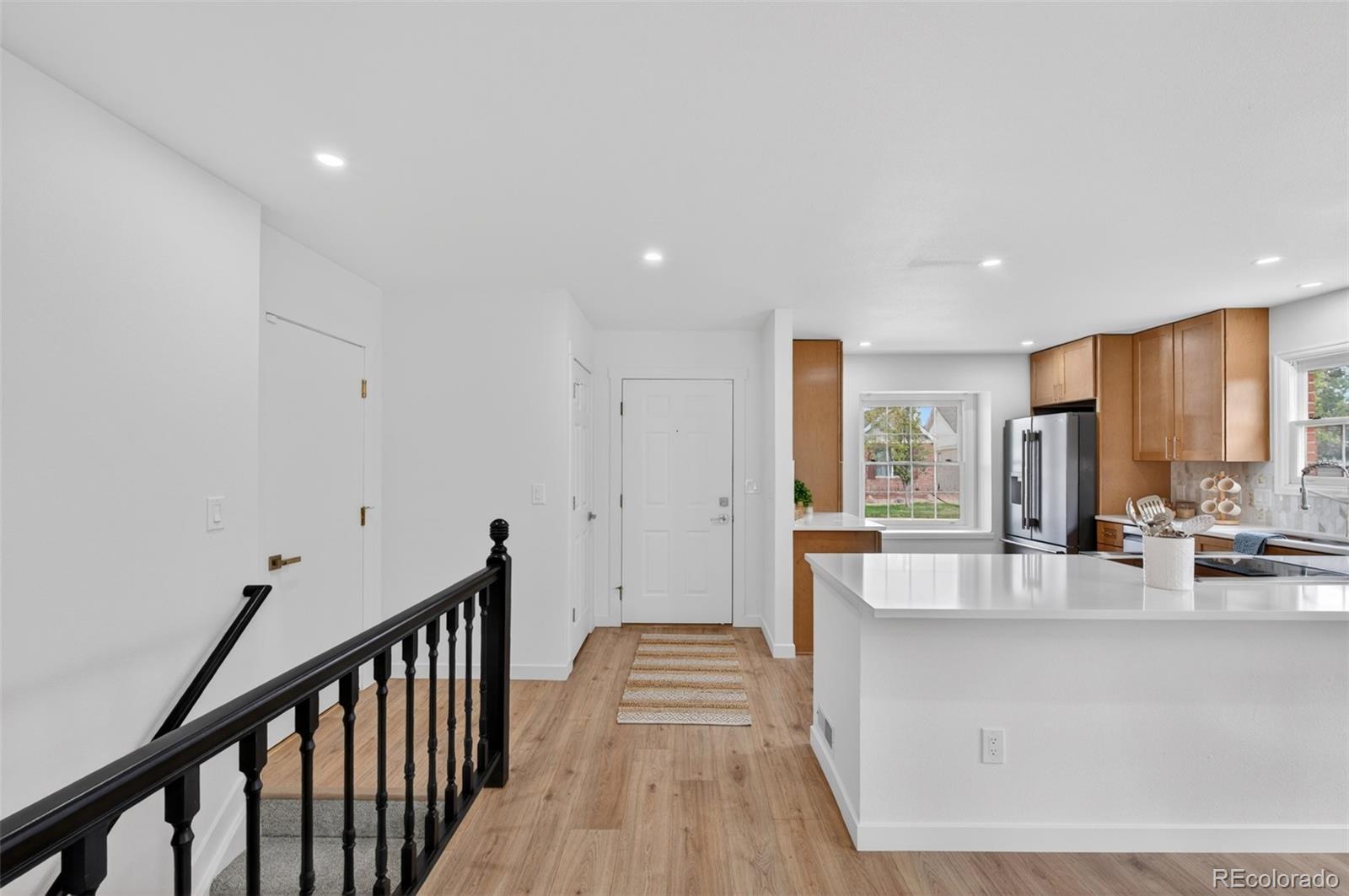 8943 Greenspointe Lane Highlands Ranch, CO 80130 - Photo 30 of 38 a view of a living room and kitchen with a large window