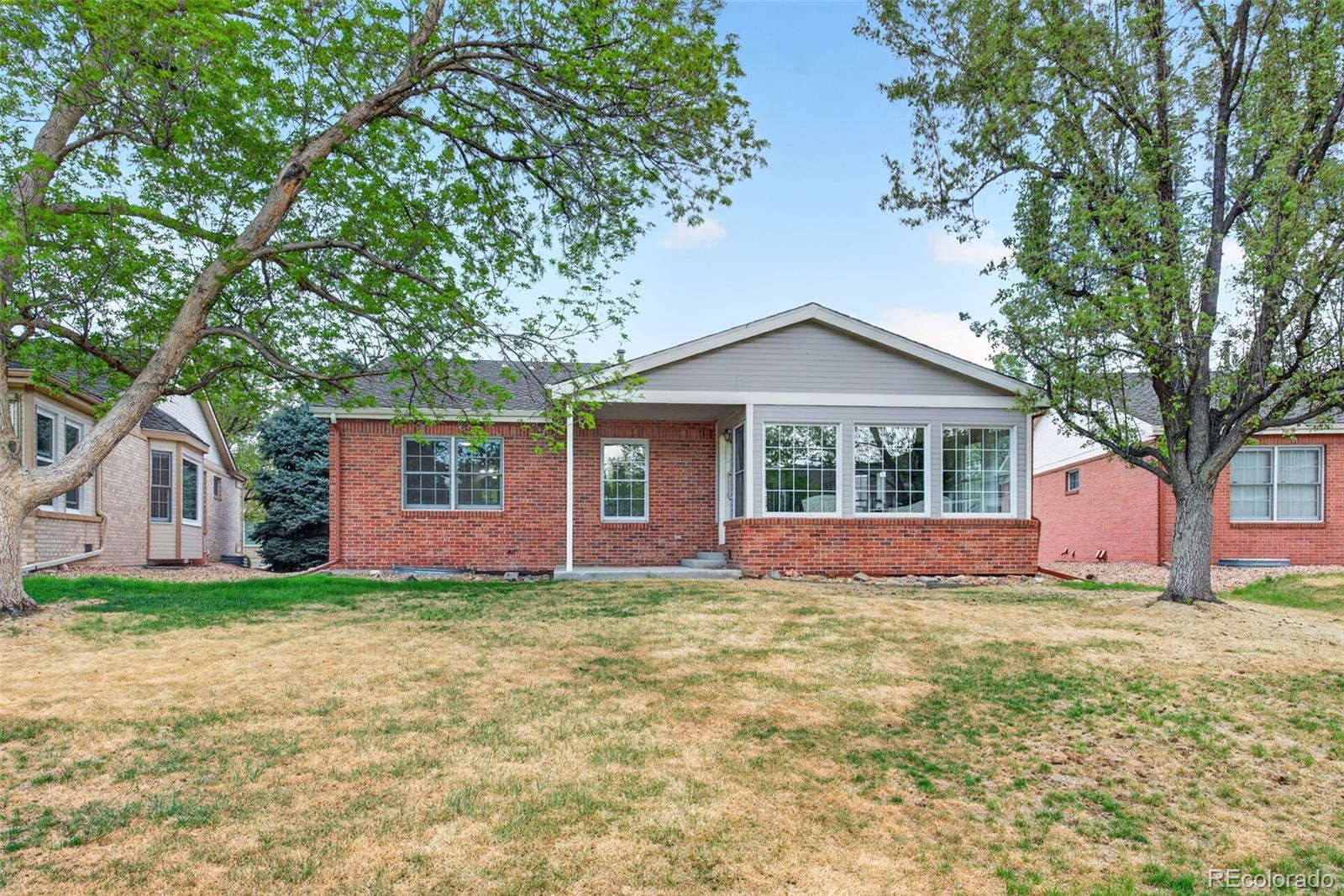 8943 Greenspointe Lane Highlands Ranch, CO 80130 - Photo 34 of 38 a front view of a house with a yard and garage