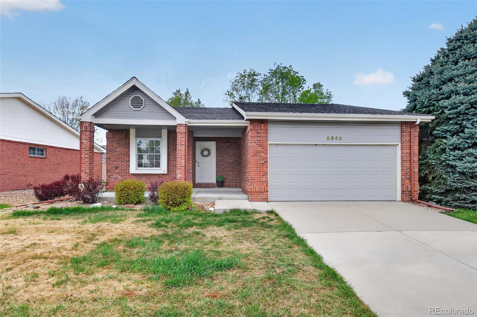 8943 Greenspointe Lane Highlands Ranch, CO 80130 - Photo 36 of 38 front view of a house with a yard