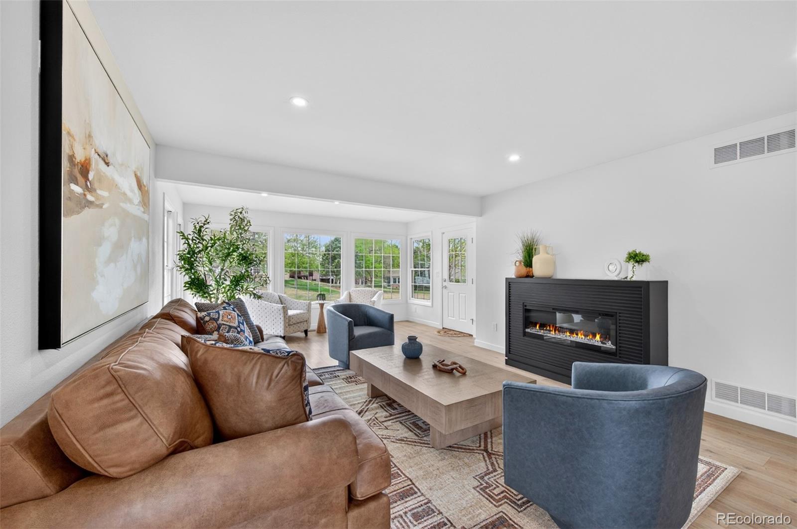 8943 Greenspointe Lane Highlands Ranch, CO 80130 - Photo 10 of 38 a living room with furniture and a fireplace