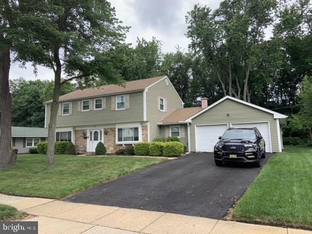 30 East Stokes Road Willingboro, NJ 08046 - Photo 1 of 26 a car parked in front of a house with a yard