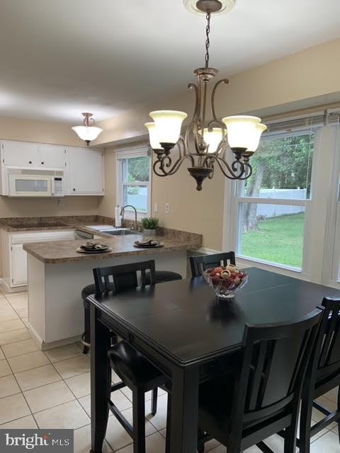 30 East Stokes Road Willingboro, NJ 08046 - Photo 11 of 26 a kitchen with a table chairs and cabinets