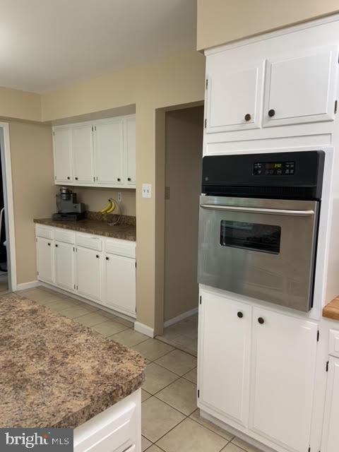 30 East Stokes Road Willingboro, NJ 08046 - Photo 13 of 26 a kitchen with granite countertop white cabinets and black appliances