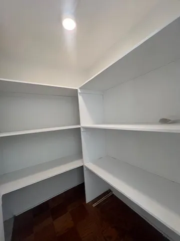 a room with a closet and wooden floor