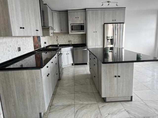 a kitchen with stainless steel appliances granite countertop a refrigerator sink and cabinets