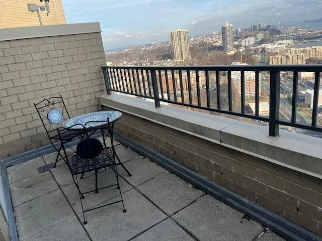 a view of a two chairs in the balcony