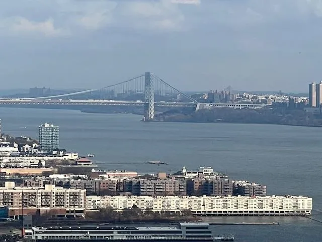 a living room with hardwood floor and a flat screen tv