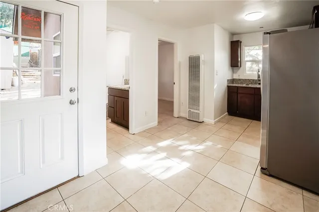a view of a kitchen with an empty space and a window