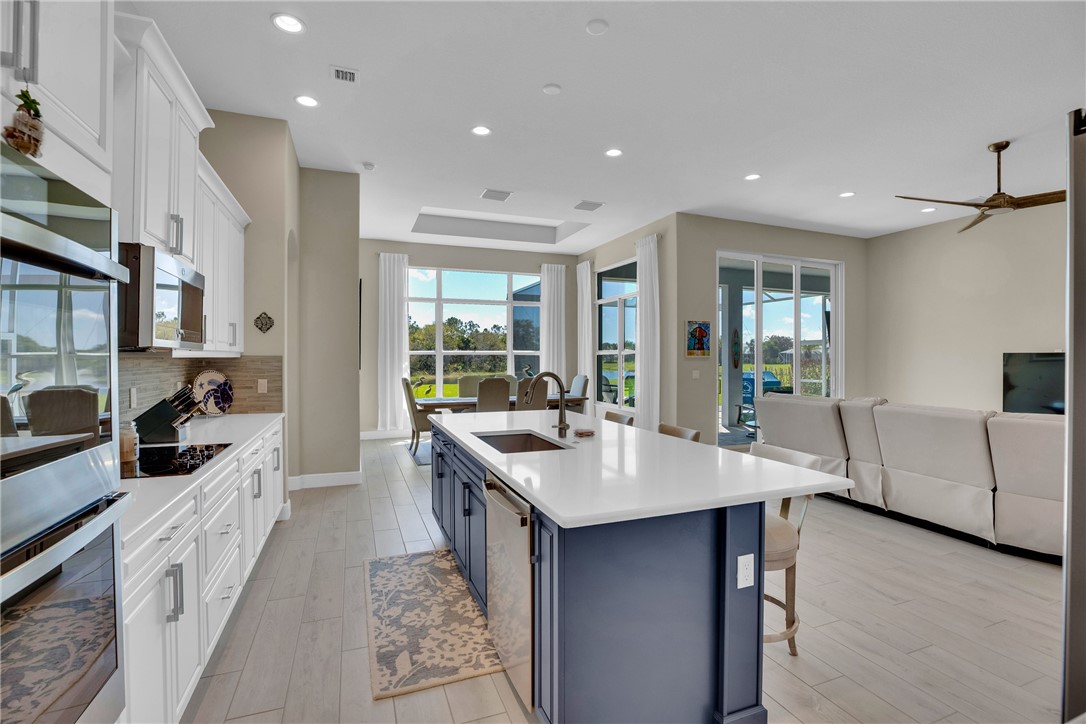 105 Night Hawk Way Sebastian, FL 32958 - Photo 7 of 36 a open kitchen with stainless steel appliances granite countertop a stove and more cabinets