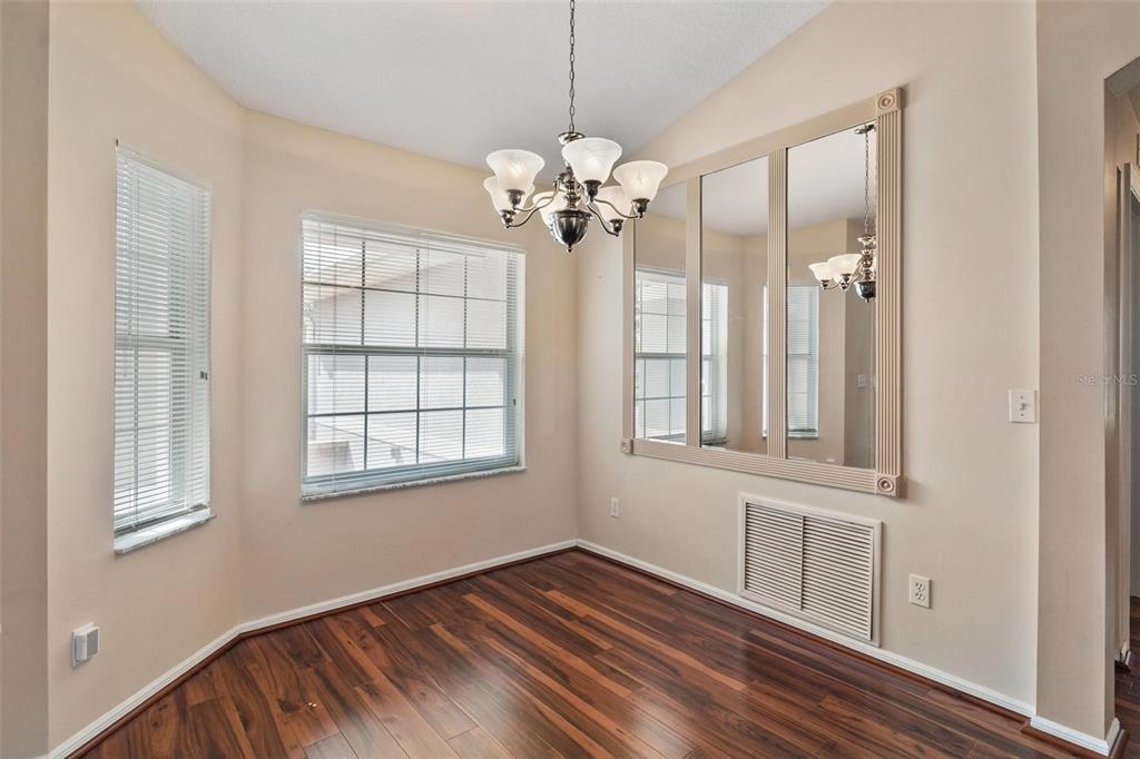 11614 Southeast 172nd Loop Summerfield, FL 34491 - Photo 12 of 55 a view of an empty room with a window and wooden floor
