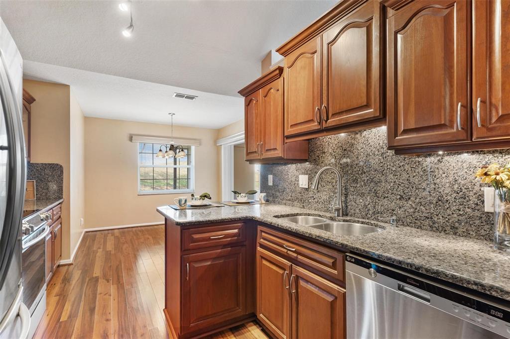 11614 Southeast 172nd Loop Summerfield, FL 34491 - Photo 15 of 55 a kitchen with stainless steel appliances granite countertop a sink stove and cabinets