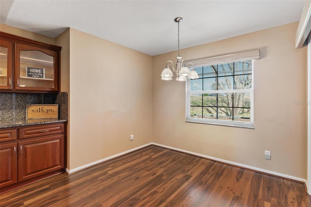 11614 Southeast 172nd Loop Summerfield, FL 34491 - Photo 16 of 55 a view of an empty room with window and wooden floor