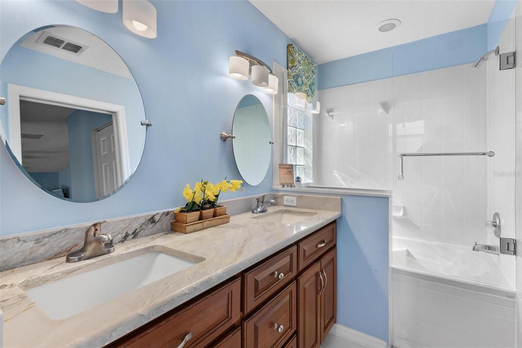 11614 Southeast 172nd Loop Summerfield, FL 34491 - Photo 20 of 55 a bathroom with a granite countertop double vanity sink and a mirror