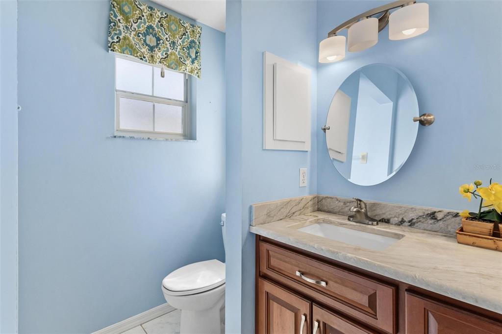 11614 Southeast 172nd Loop Summerfield, FL 34491 - Photo 21 of 55 a bathroom with a granite countertop toilet sink and mirror