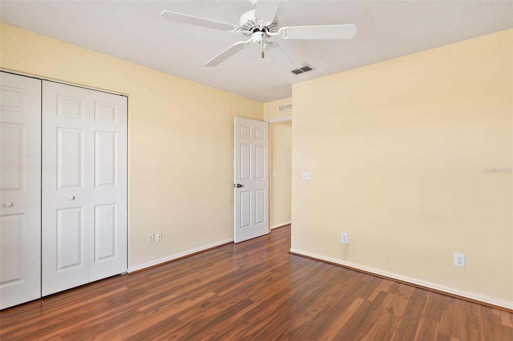 11614 Southeast 172nd Loop Summerfield, FL 34491 - Photo 25 of 55 an empty room with wooden floor and a ceiling fan